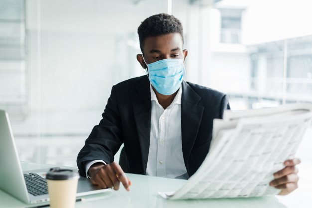 A man wearing a face mask in the office