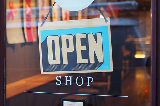 a shop displaying a sign that it’s OPEN