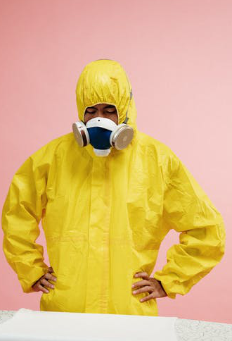 An industrial worker wearing a yellow coverall hazmat suit.